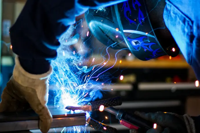 A person holding a grey steel frame
